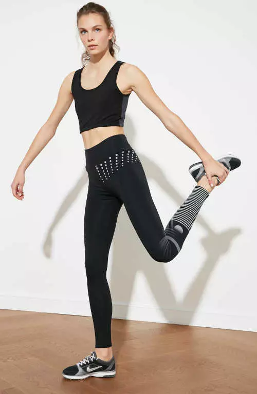 Női sportos fekete leggings mintával a lábszárán